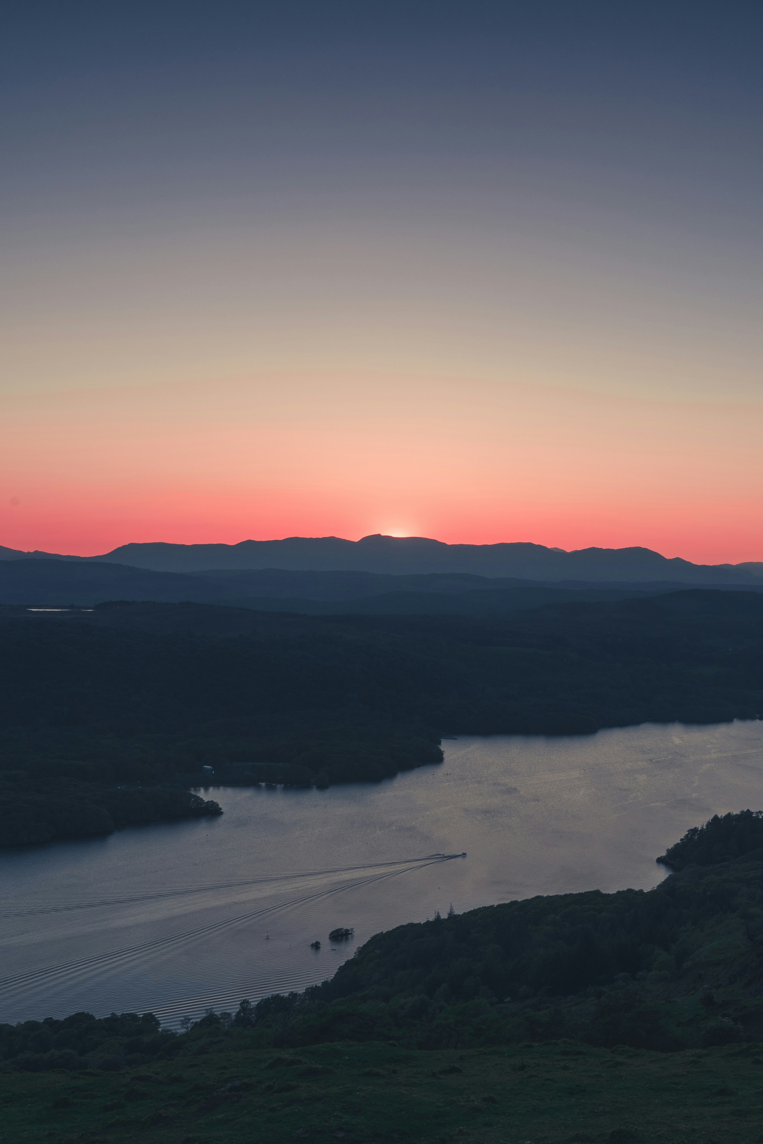 the sun is setting over a body of water