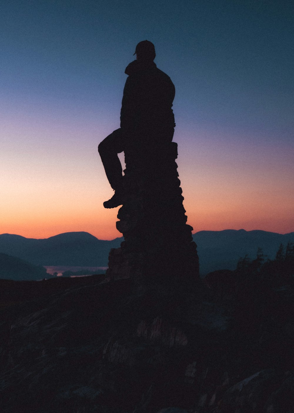 a man standing on top of a pile of rocks