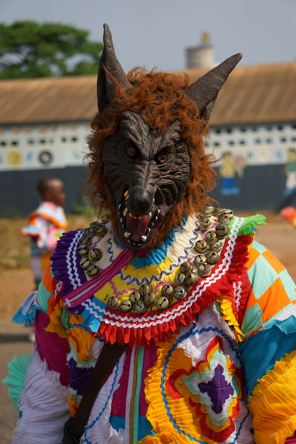 brown and black animal wearing yellow and pink dress