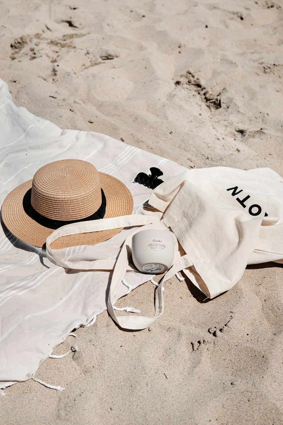 brown and white sun hat on white textile