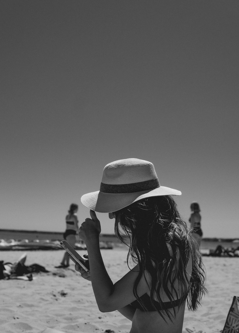 grayscale photo of woman wearing sun hat