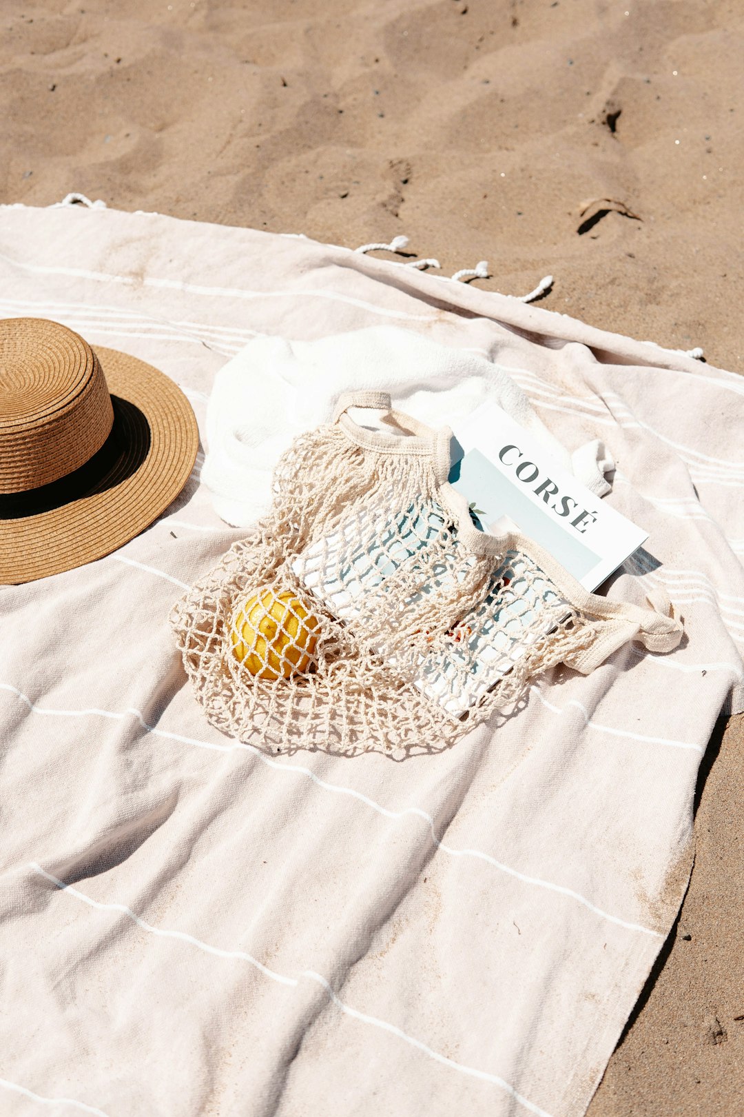 brown straw hat on white textile