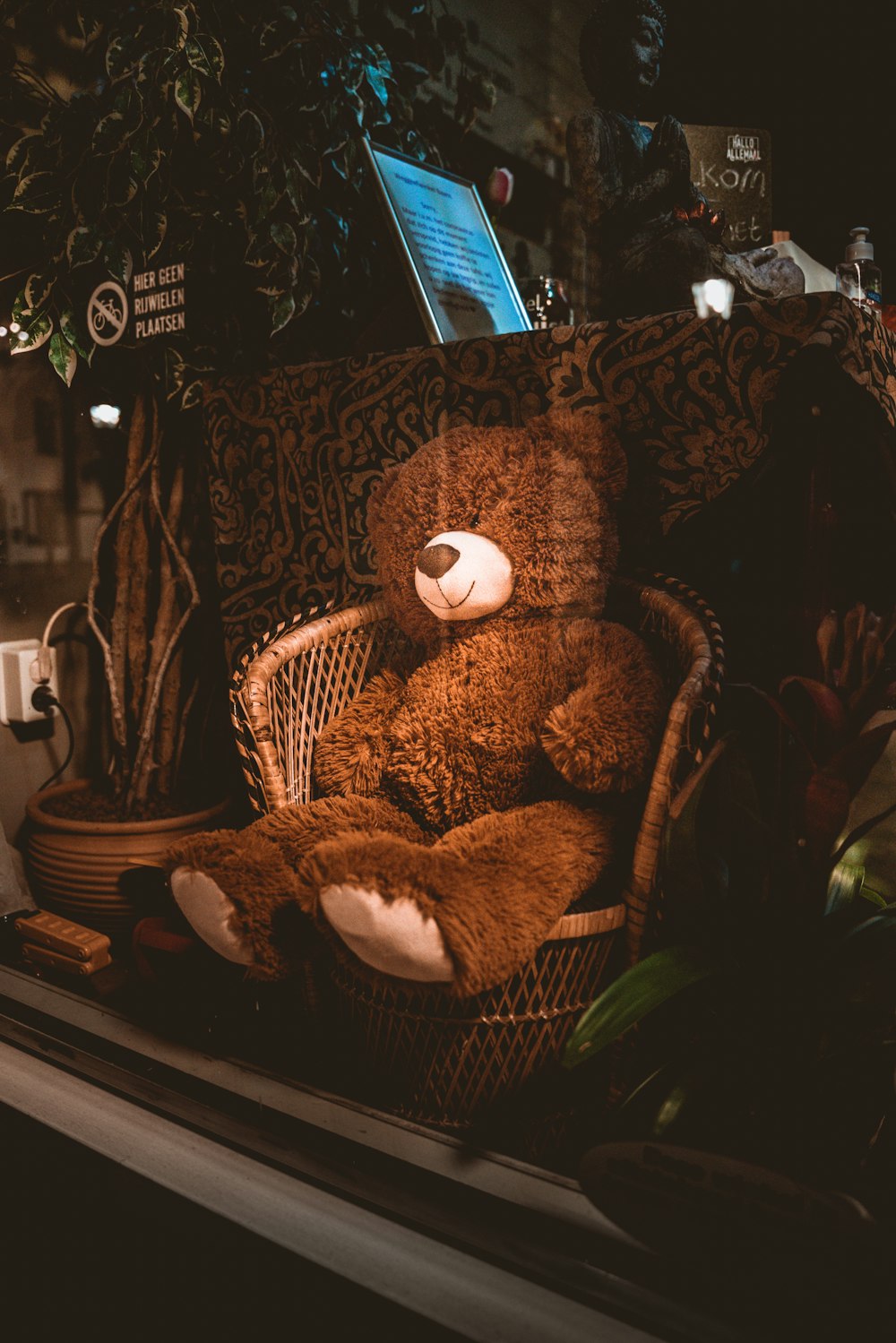 brown teddy bear on brown sofa chair