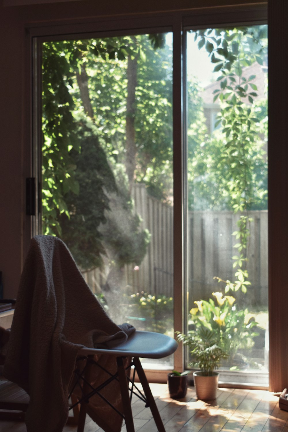 white framed glass window with white curtain