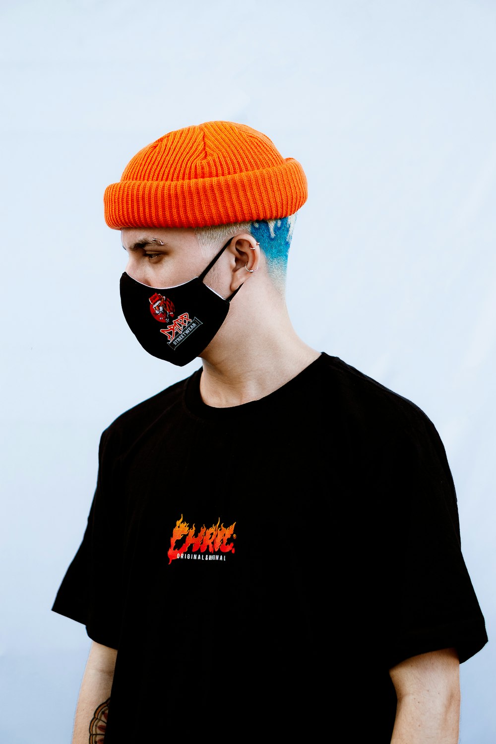 man in black crew neck shirt wearing orange knit cap