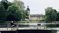 people sitting on bench near body of water during daytime