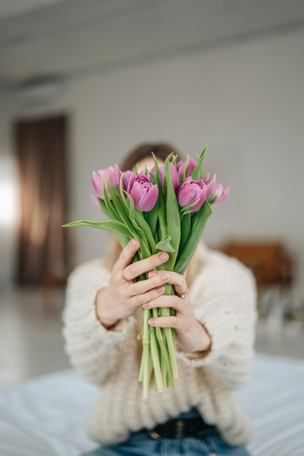 person holding purple and white flower