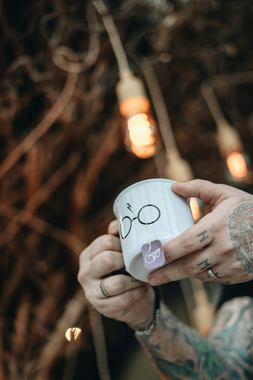 person holding white ceramic mug