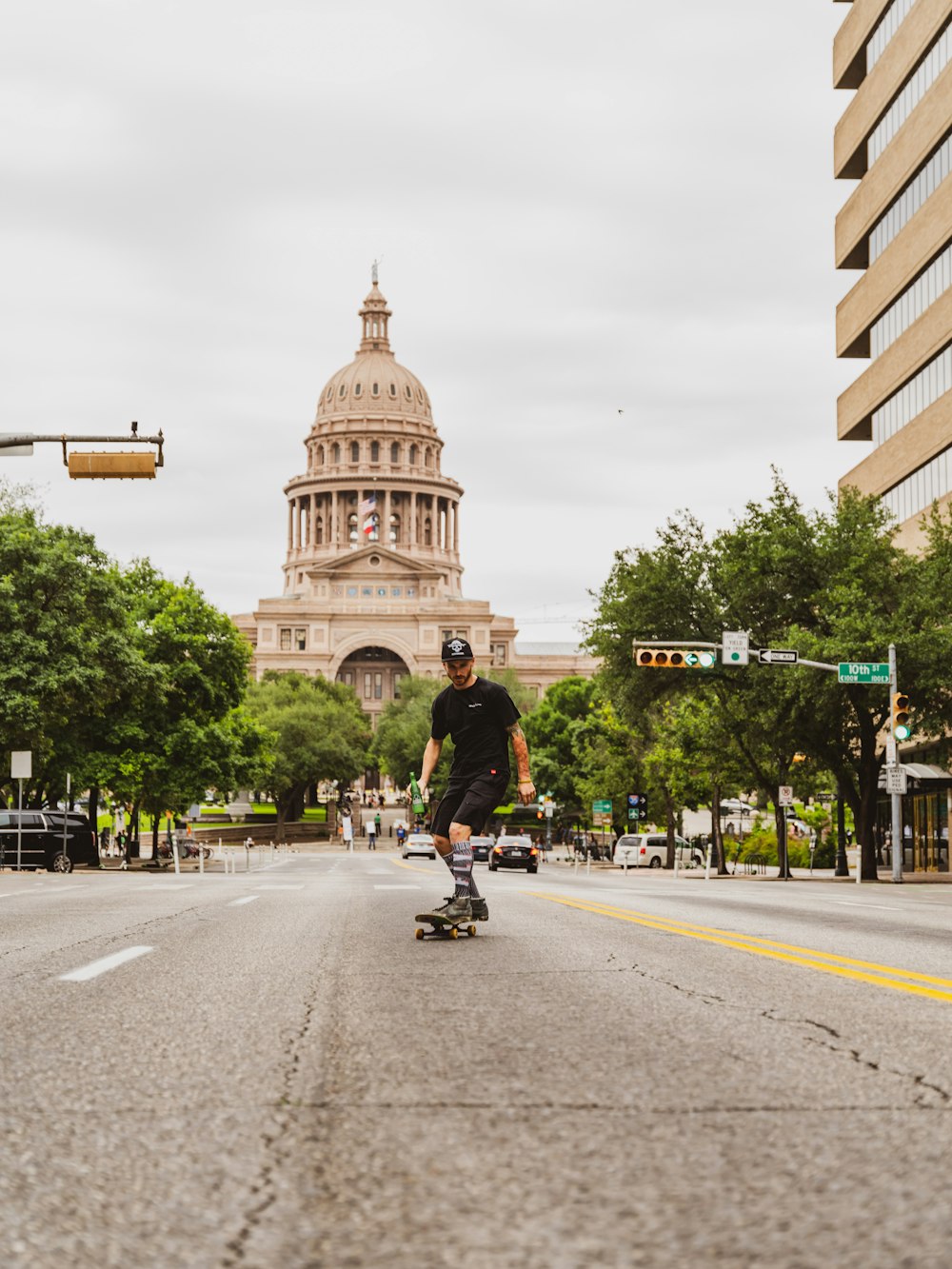 man riding bicycle on road near brown concrete building during daytime