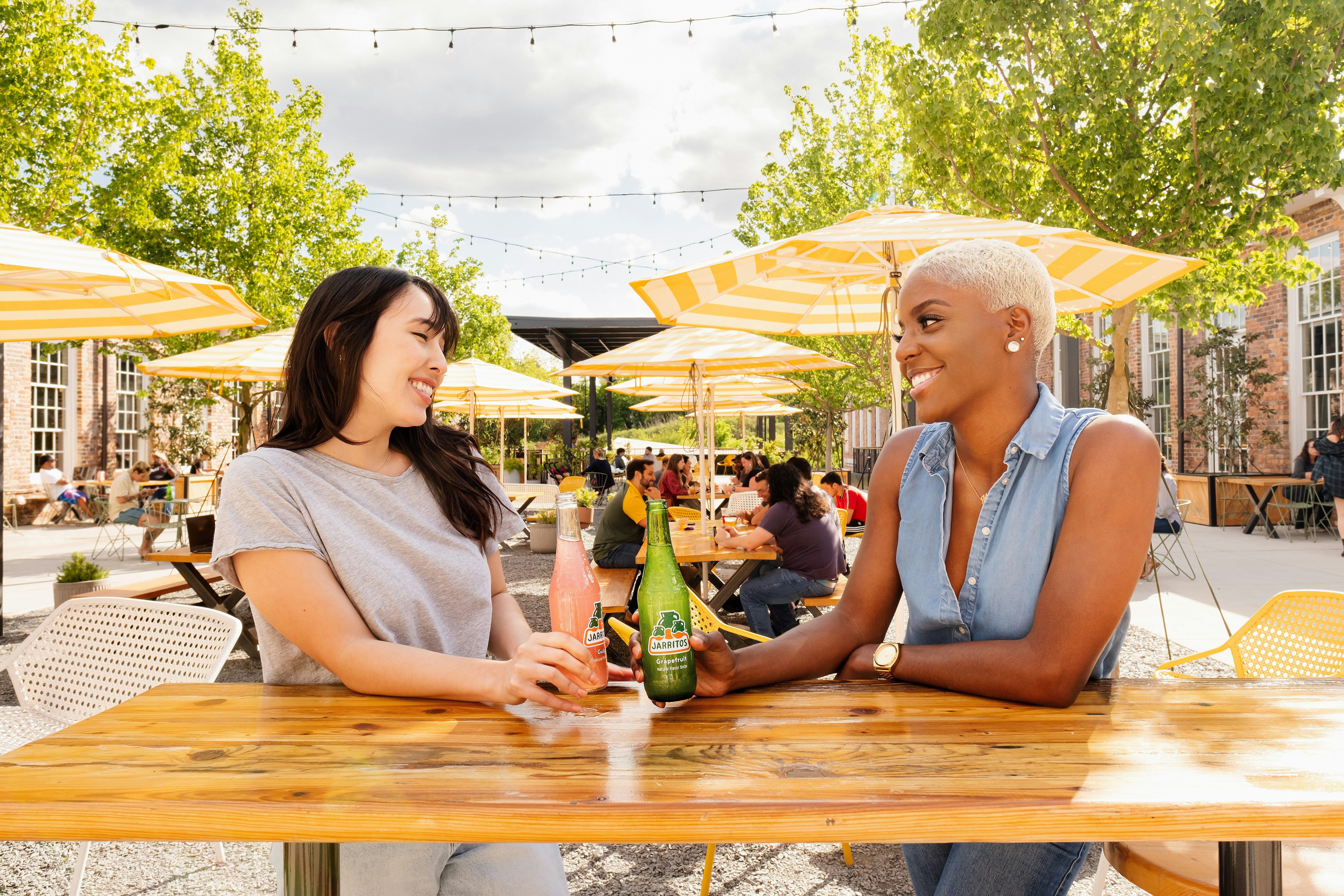 man and woman sitting on picnic table, Jarritos and Patio Hangout