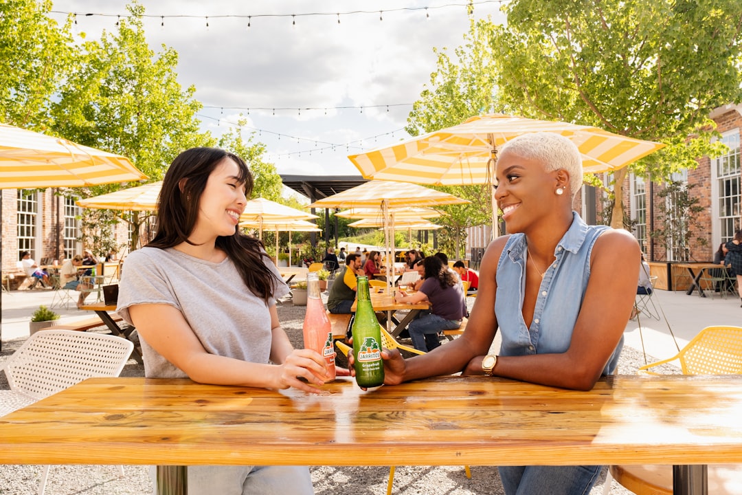 man and woman sitting on picnic table, Jarritos and Patio Hangout