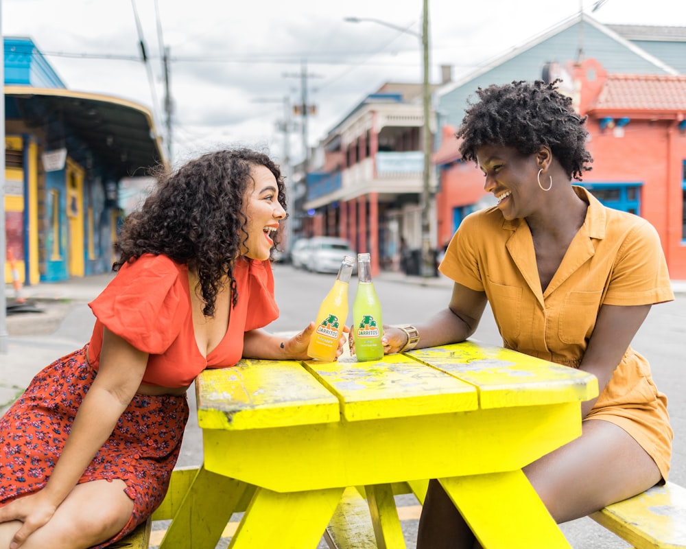 man and woman sitting on chair in front of table with yellow table cloth