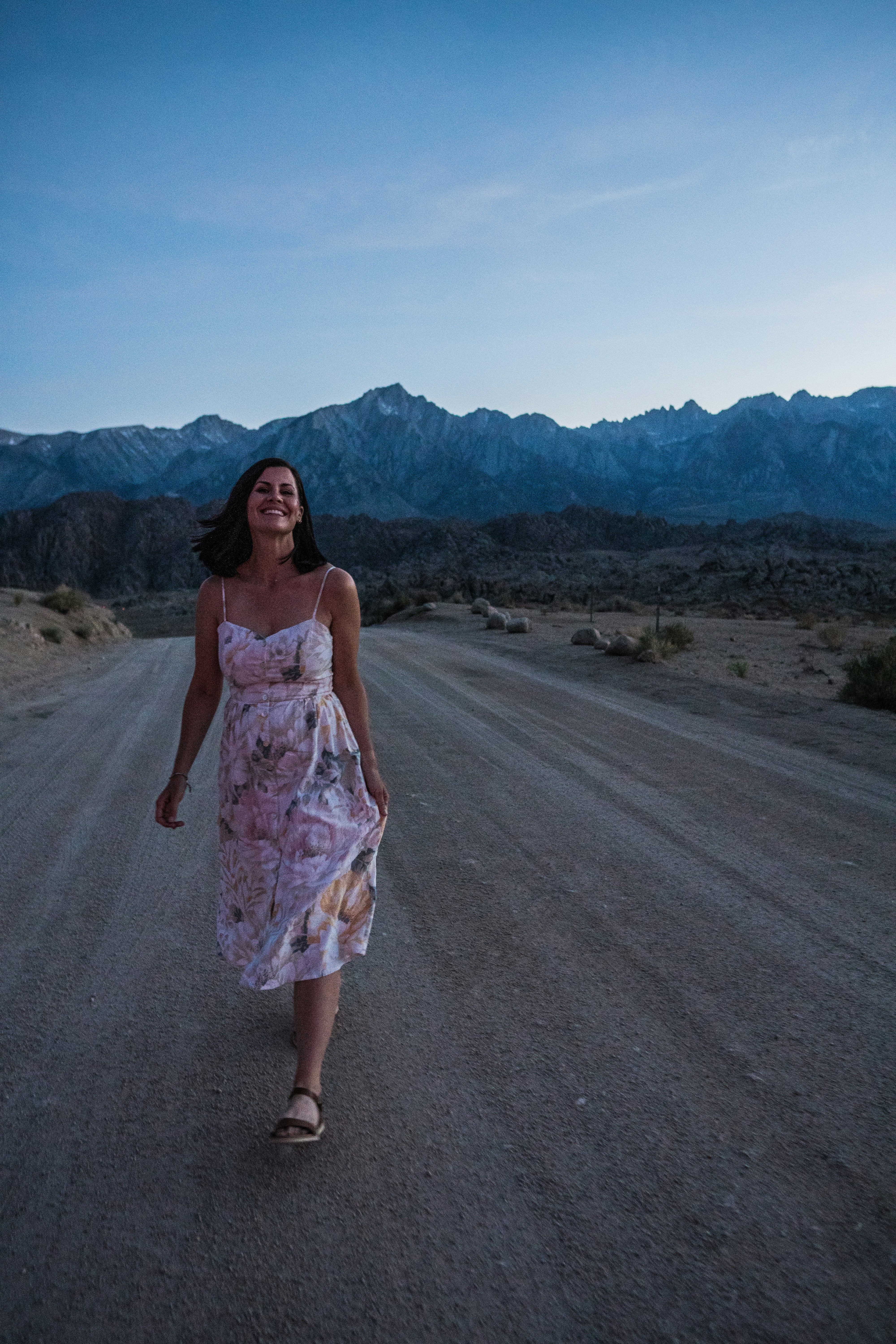 Beautiful woman walking on dirt road in California.