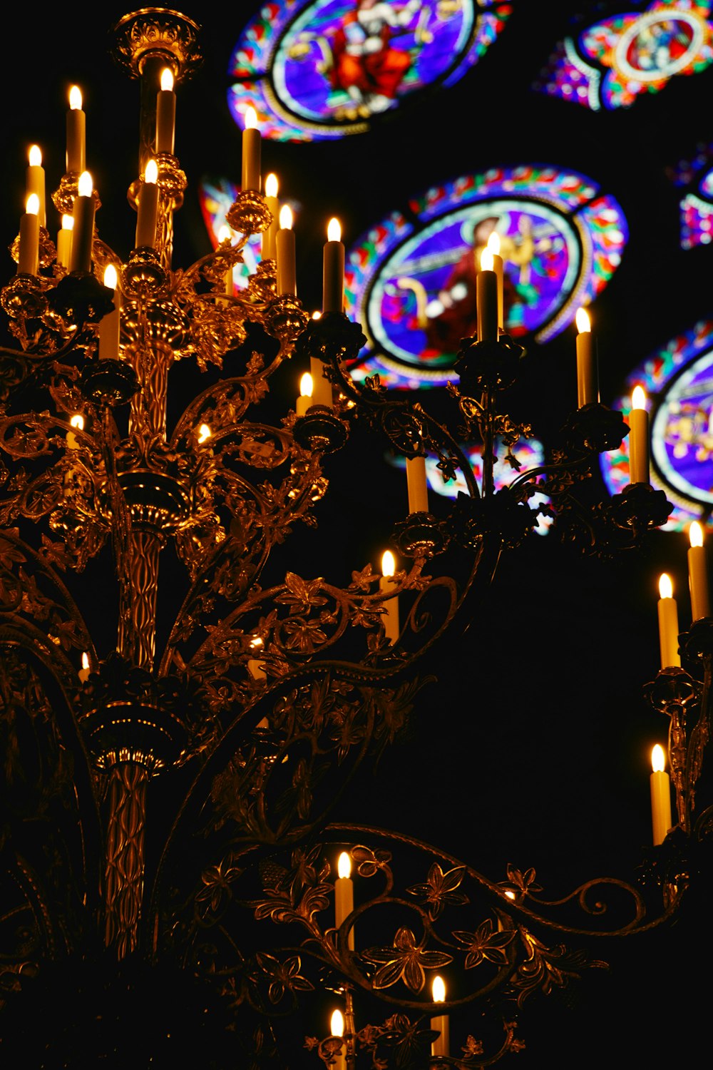 brass uplight chandelier turned on during nighttime
