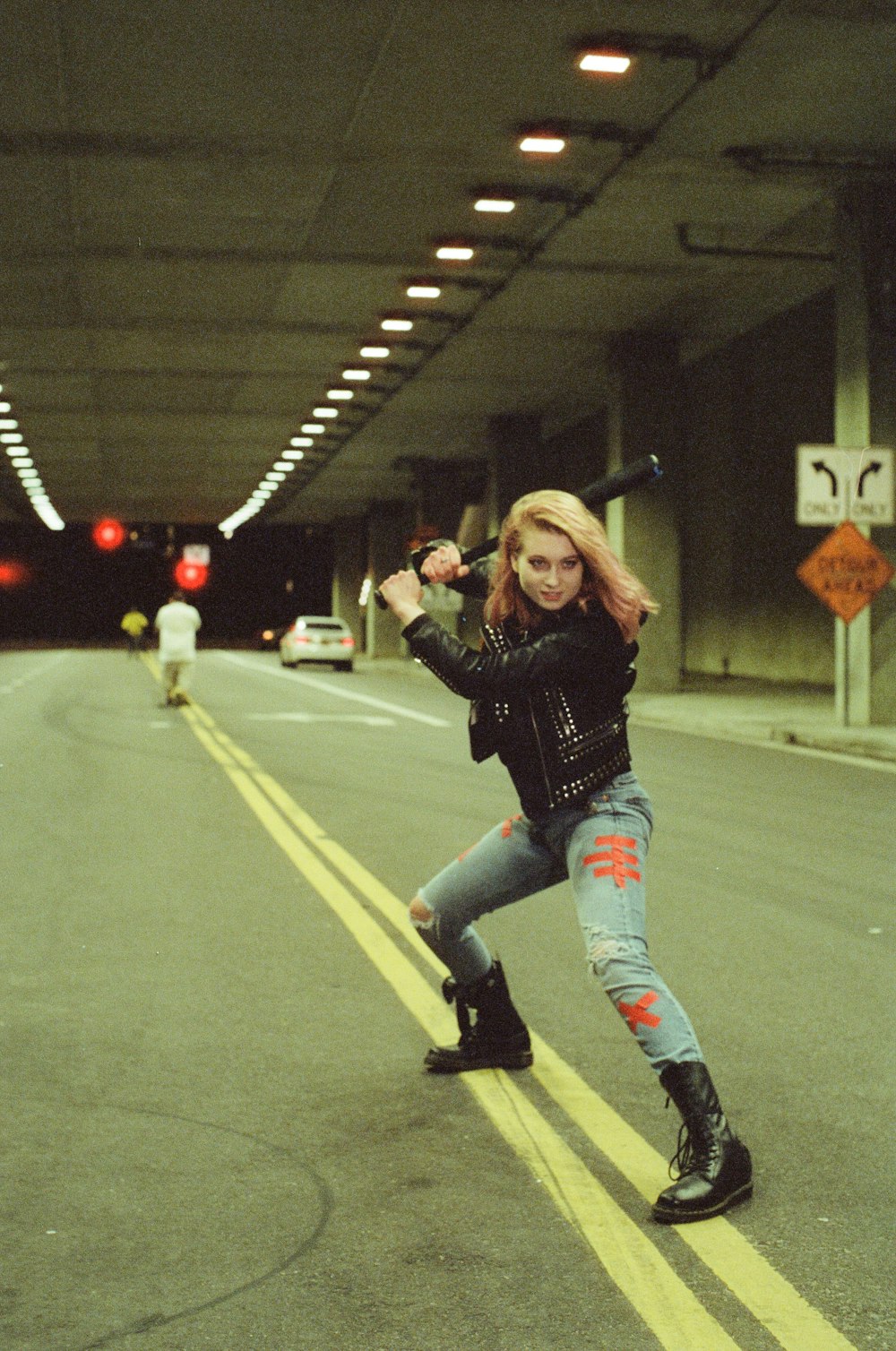 woman in black long sleeve shirt and blue denim jeans running on road
