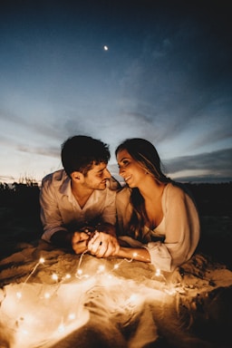 the journey ahead,how to photograph man and woman kissing on sand during daytime
