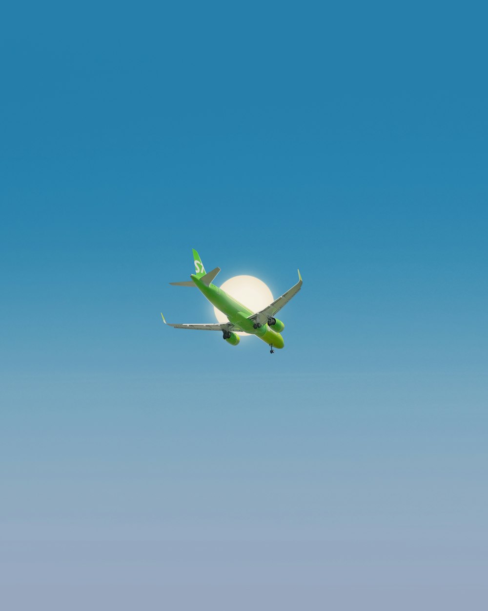 white and green airplane flying under blue sky during daytime