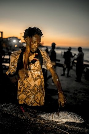An elegant chef preparing a gourmet meal aboard a private yacht at sunset