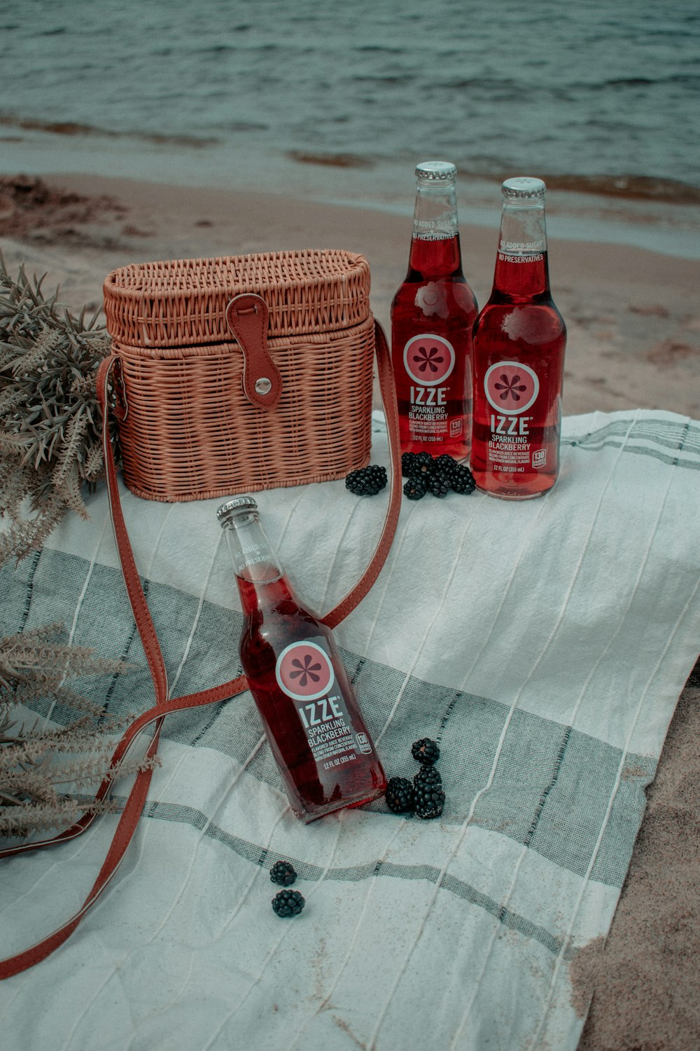 red and white labeled bottle beside brown woven basket