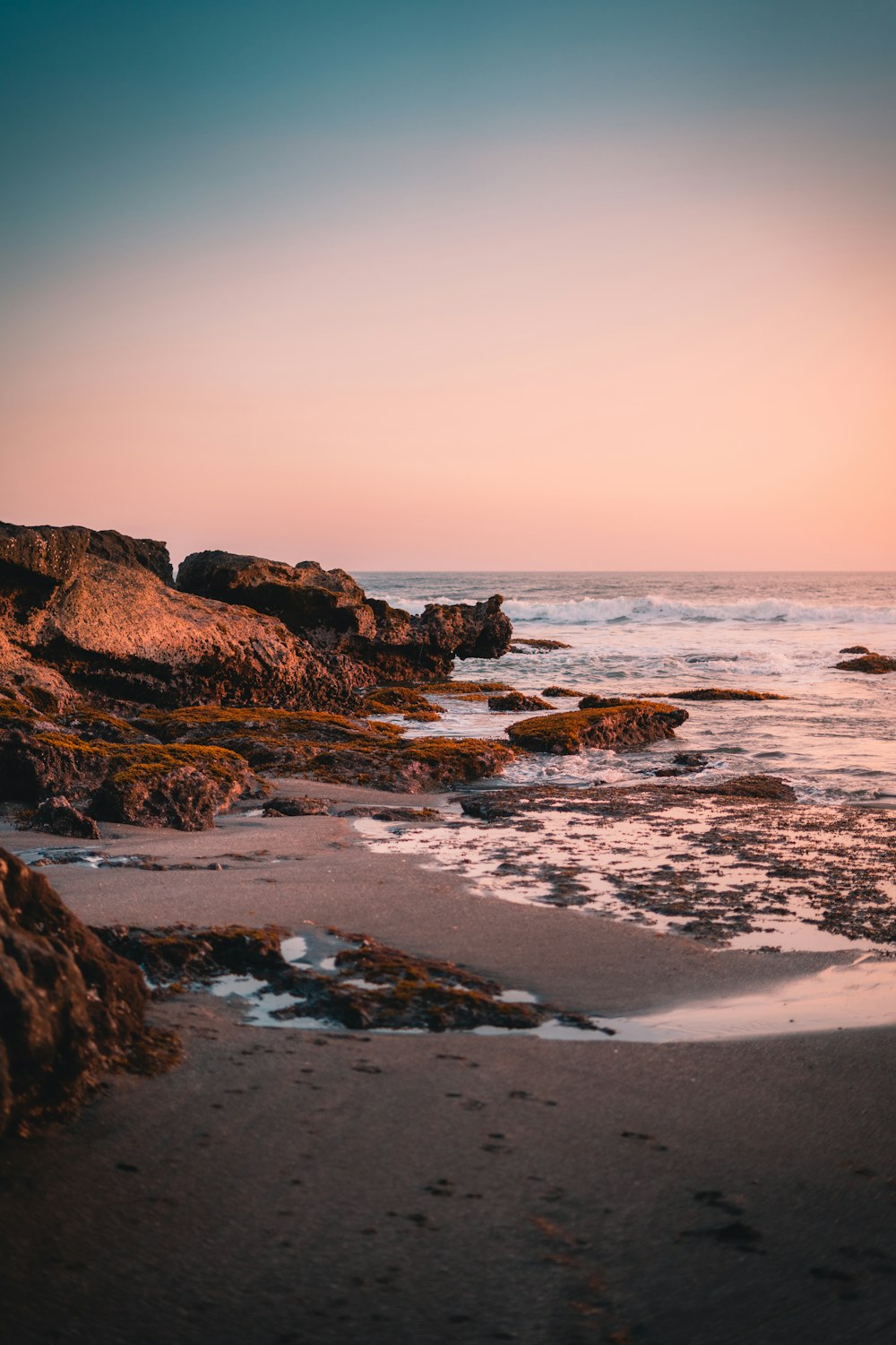 a beach with rocks and a body of water