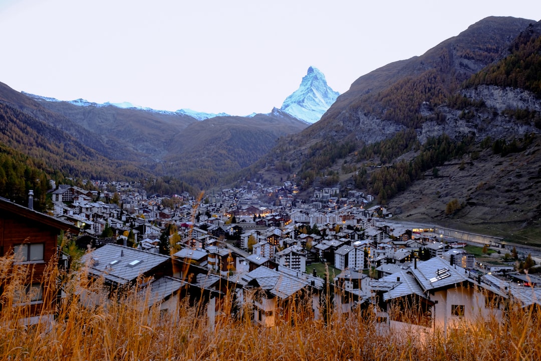 white and brown houses near mountain during daytime