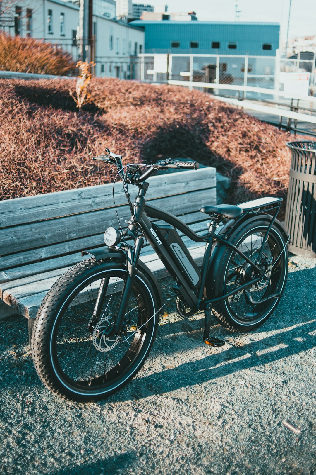 black bicycle parked beside wooden bench