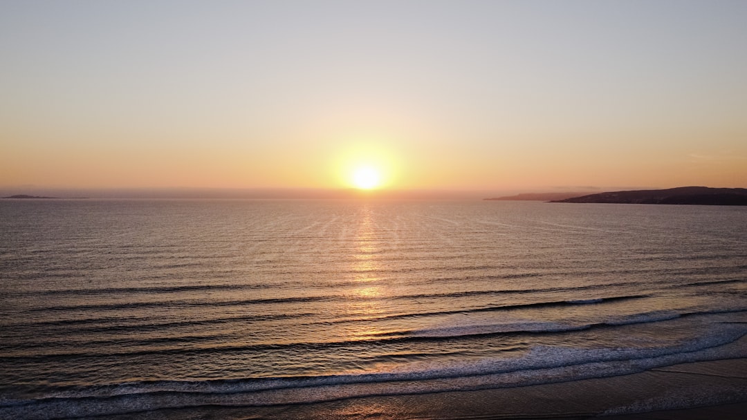 body of water during sunset