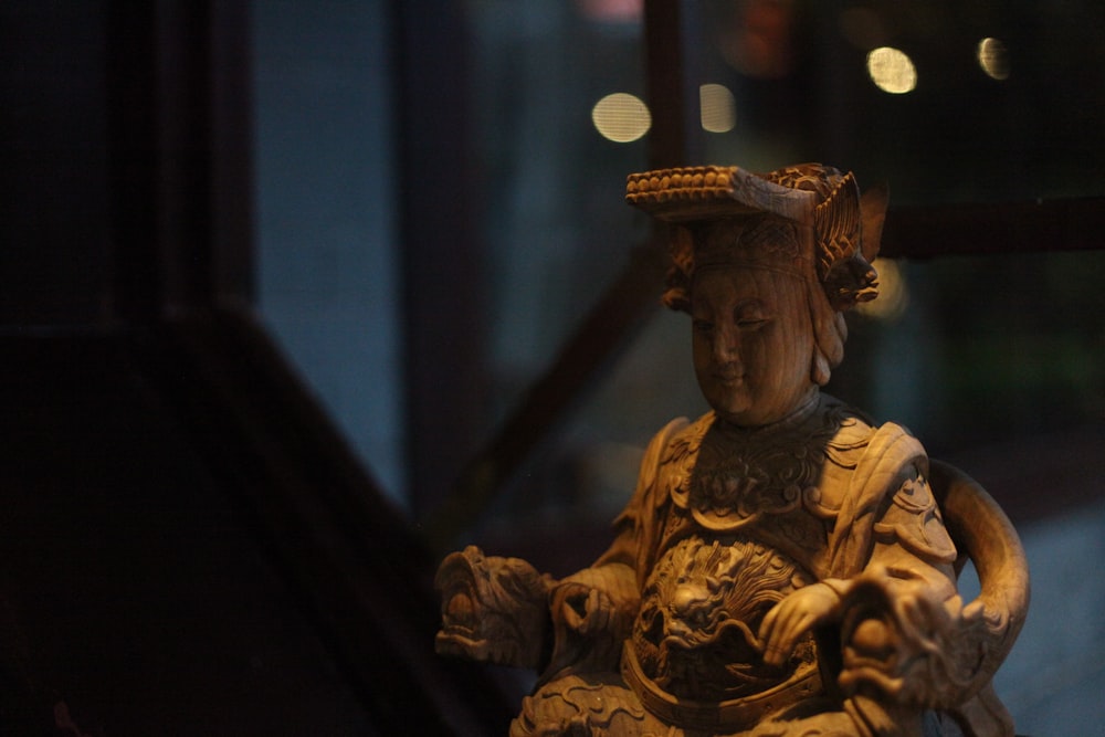 gold buddha figurine on black table