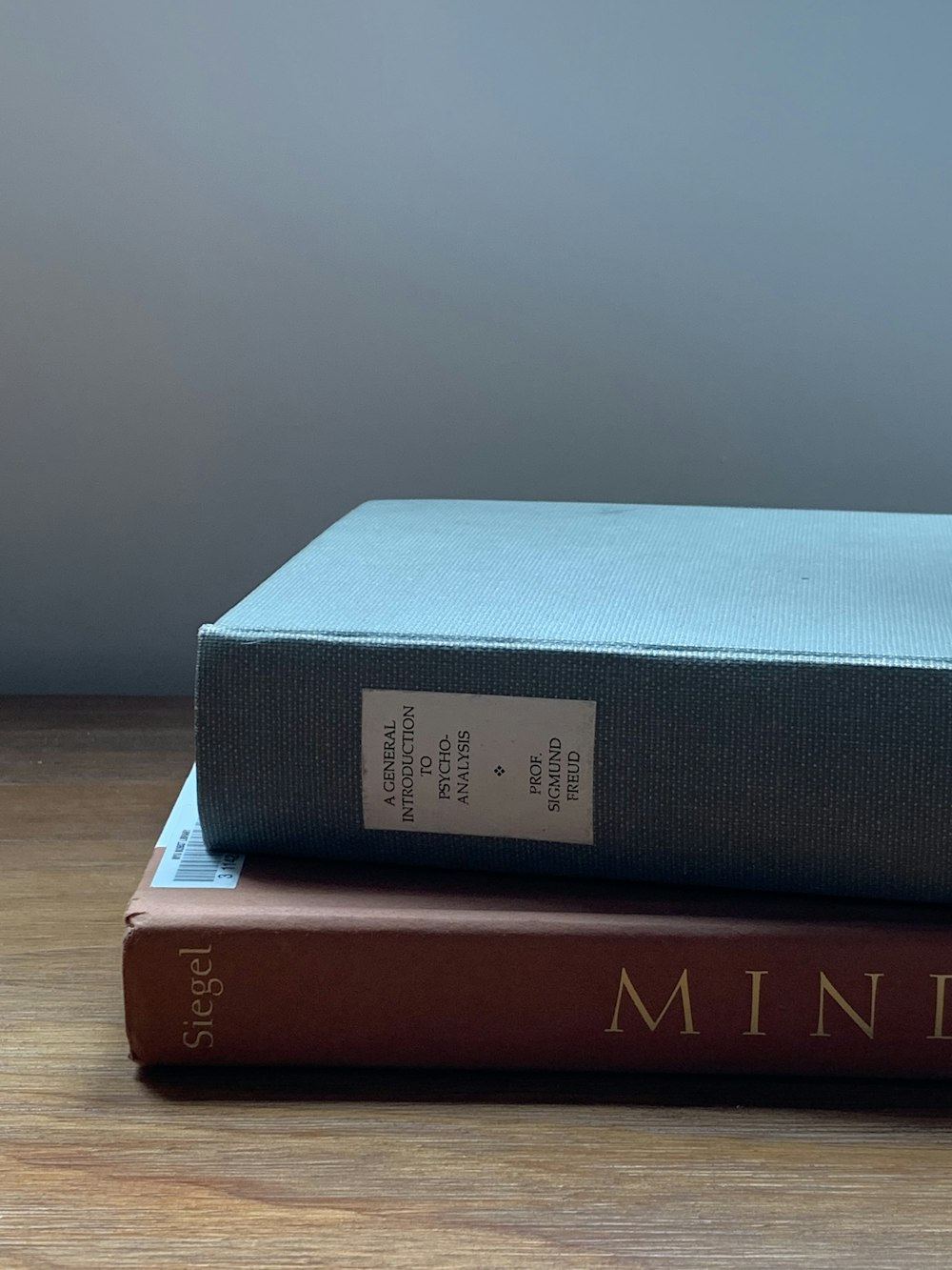 blue and red book on brown wooden table