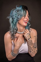 woman in white tank top with green hair