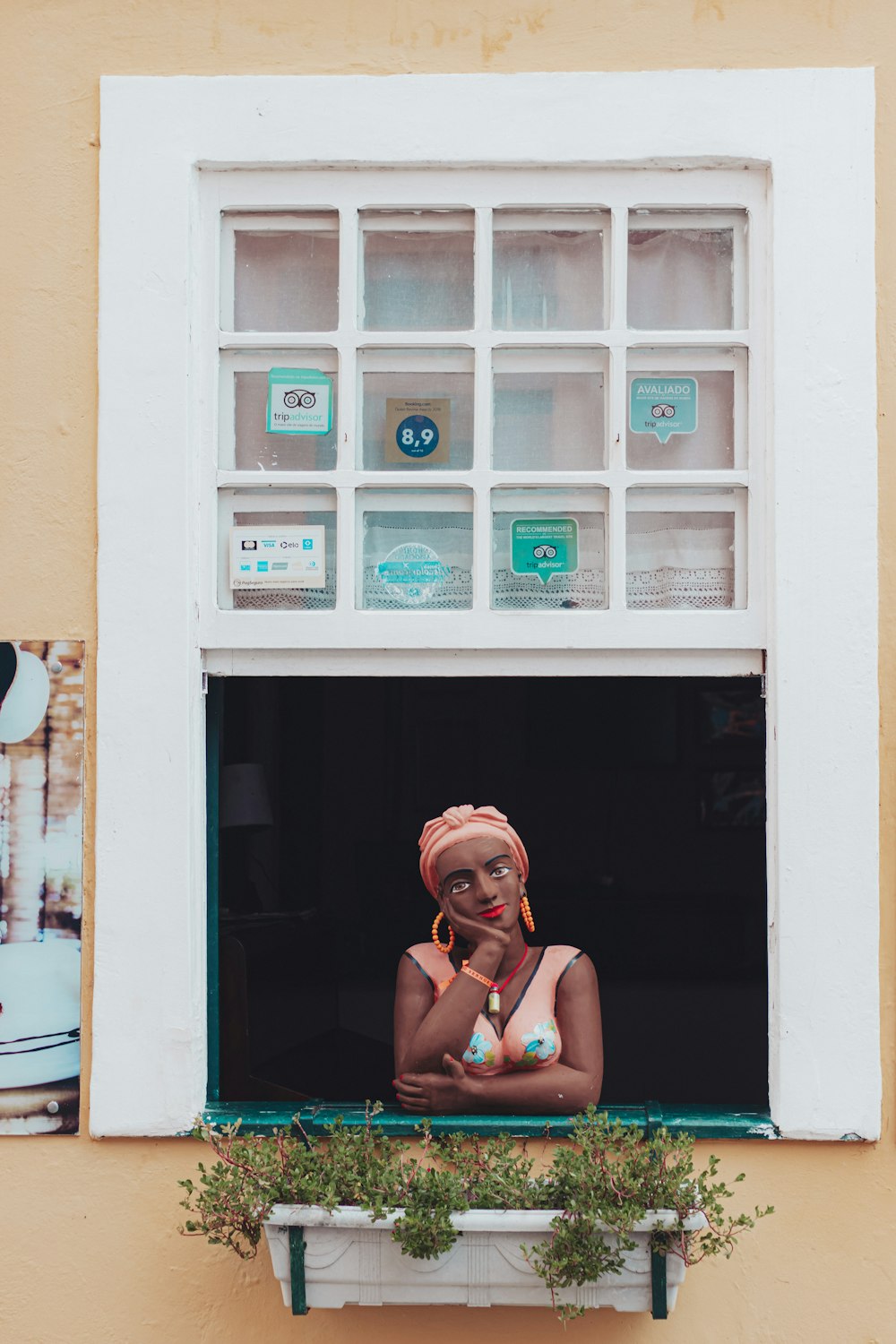 woman in black tank top wearing eyeglasses sitting on window during daytime