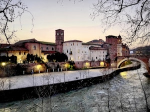 brown concrete building near river during daytime