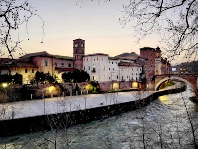 brown concrete building near river during daytime