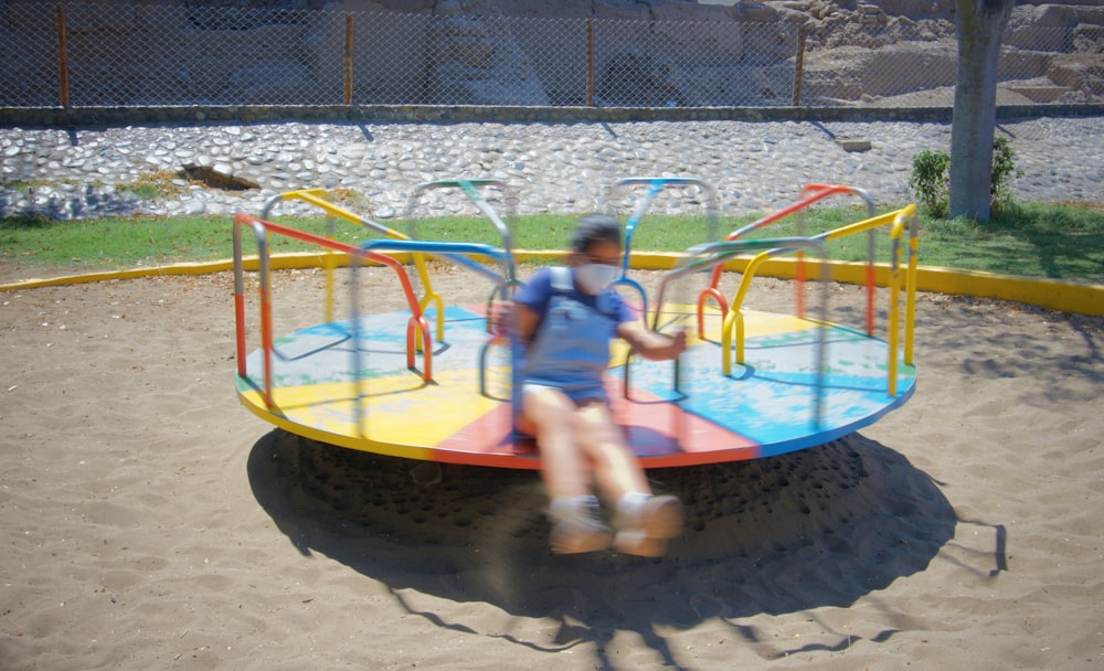 2 children playing on yellow and blue trampoline