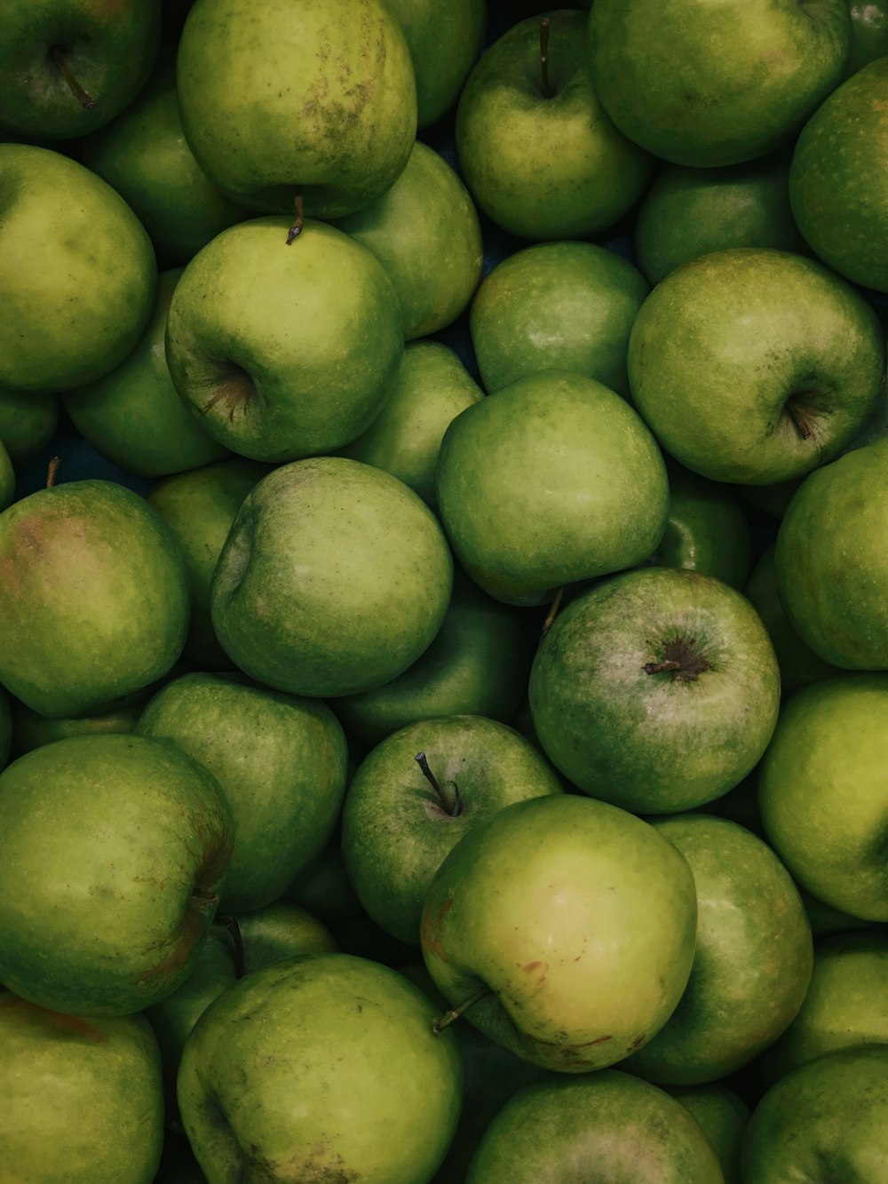 green apples on brown wooden table