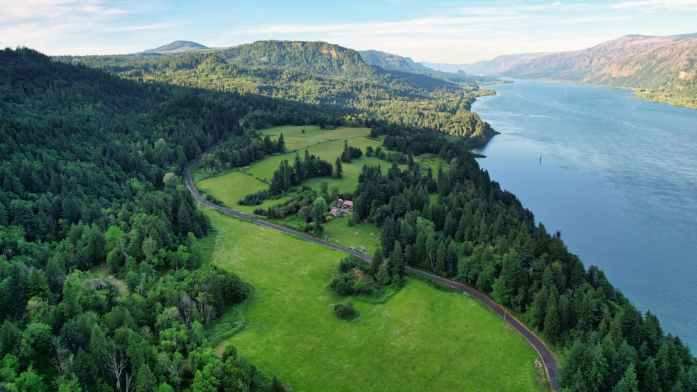 green grass field near body of water during daytime