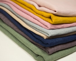 Stacks of colorful clothing samples ready to become something special.