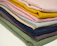 A neatly stacked set of colorful collapsible fabric storage bins in a bright closet.