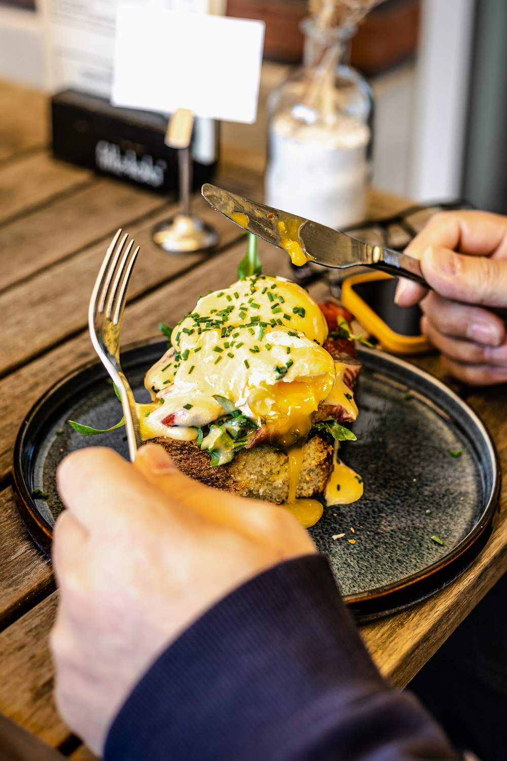 person holding stainless steel fork and knife