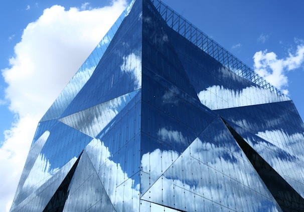 blue and white glass building under blue sky during daytime