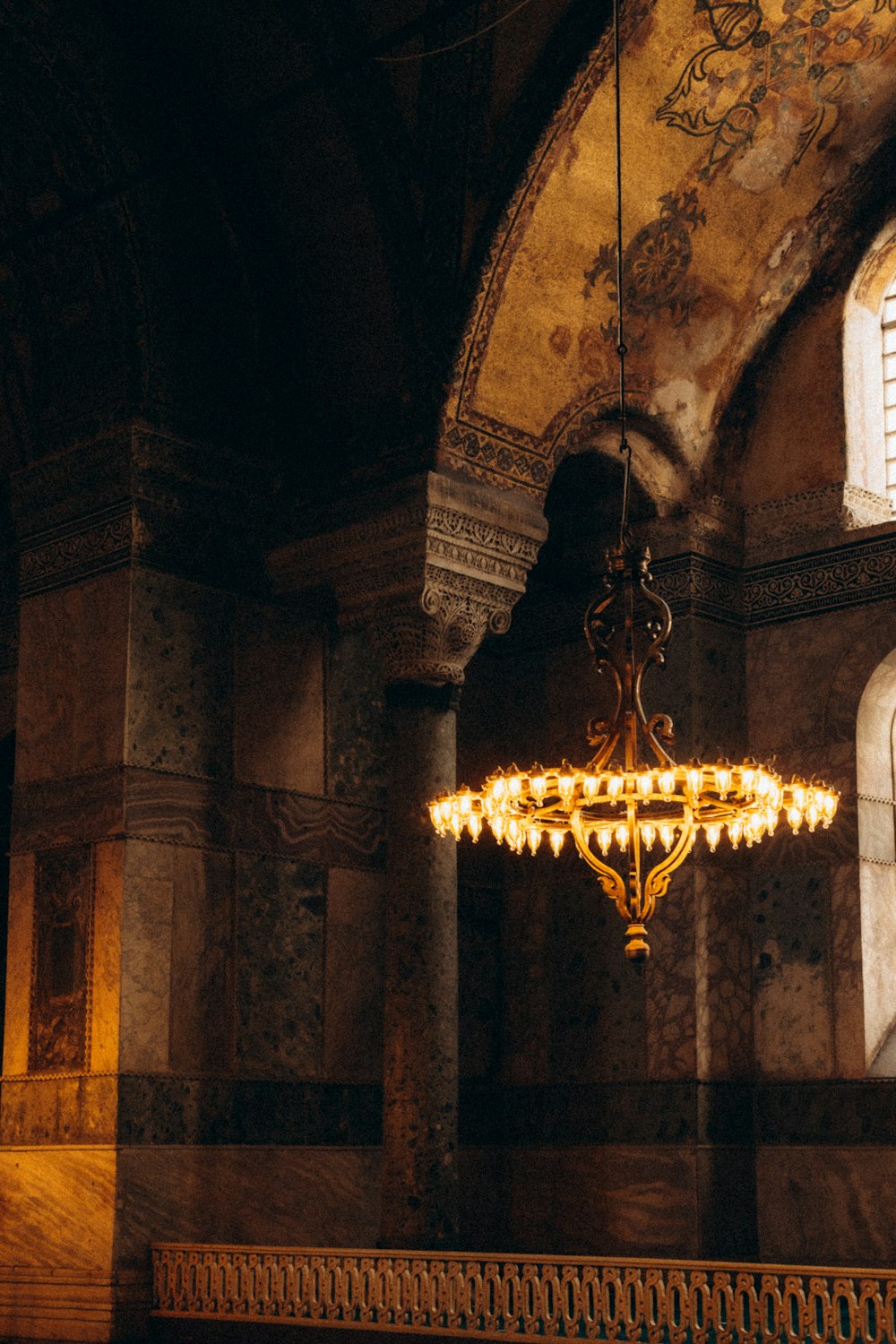 brass chandelier turned on in a room