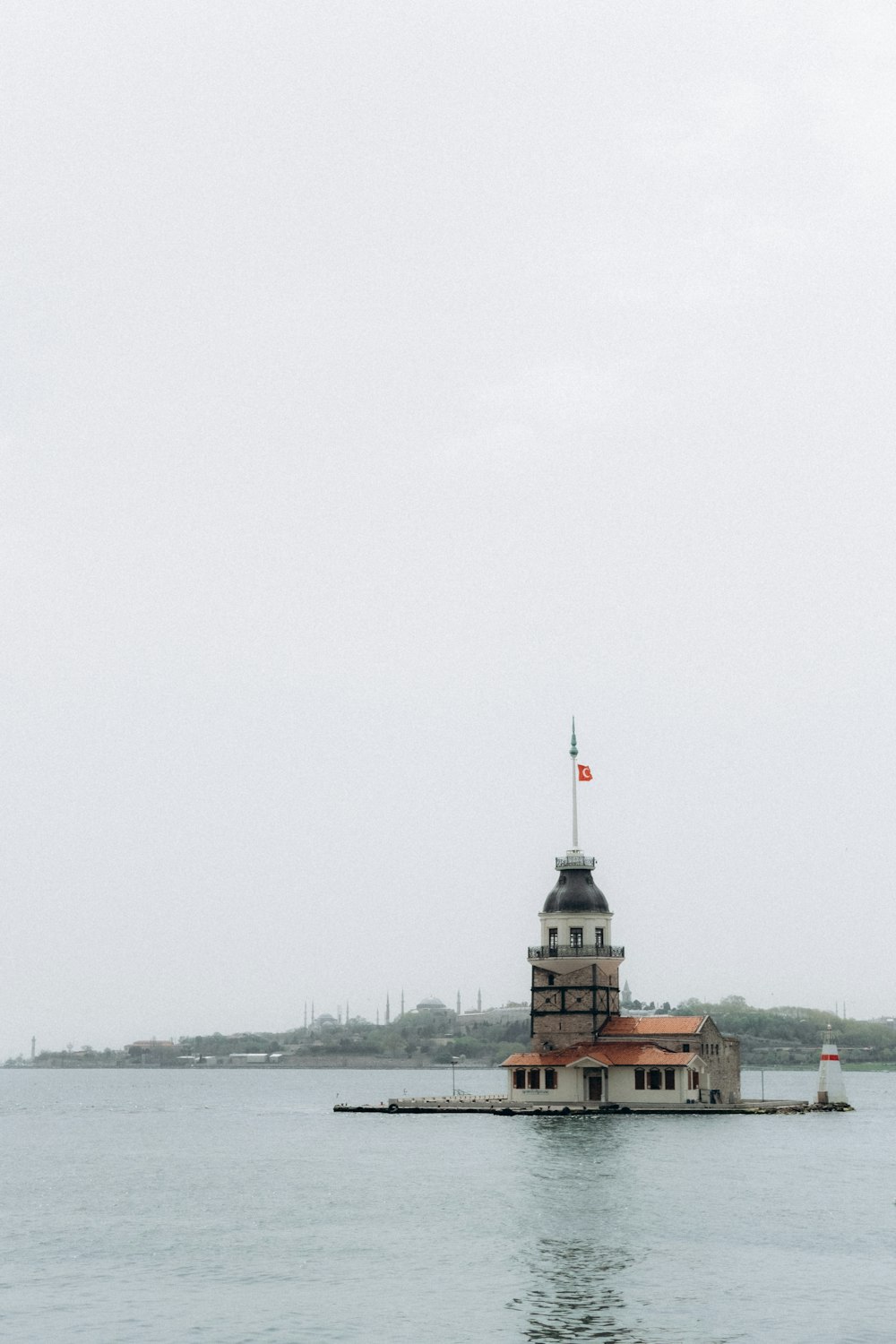 brown and white concrete building near body of water during daytime