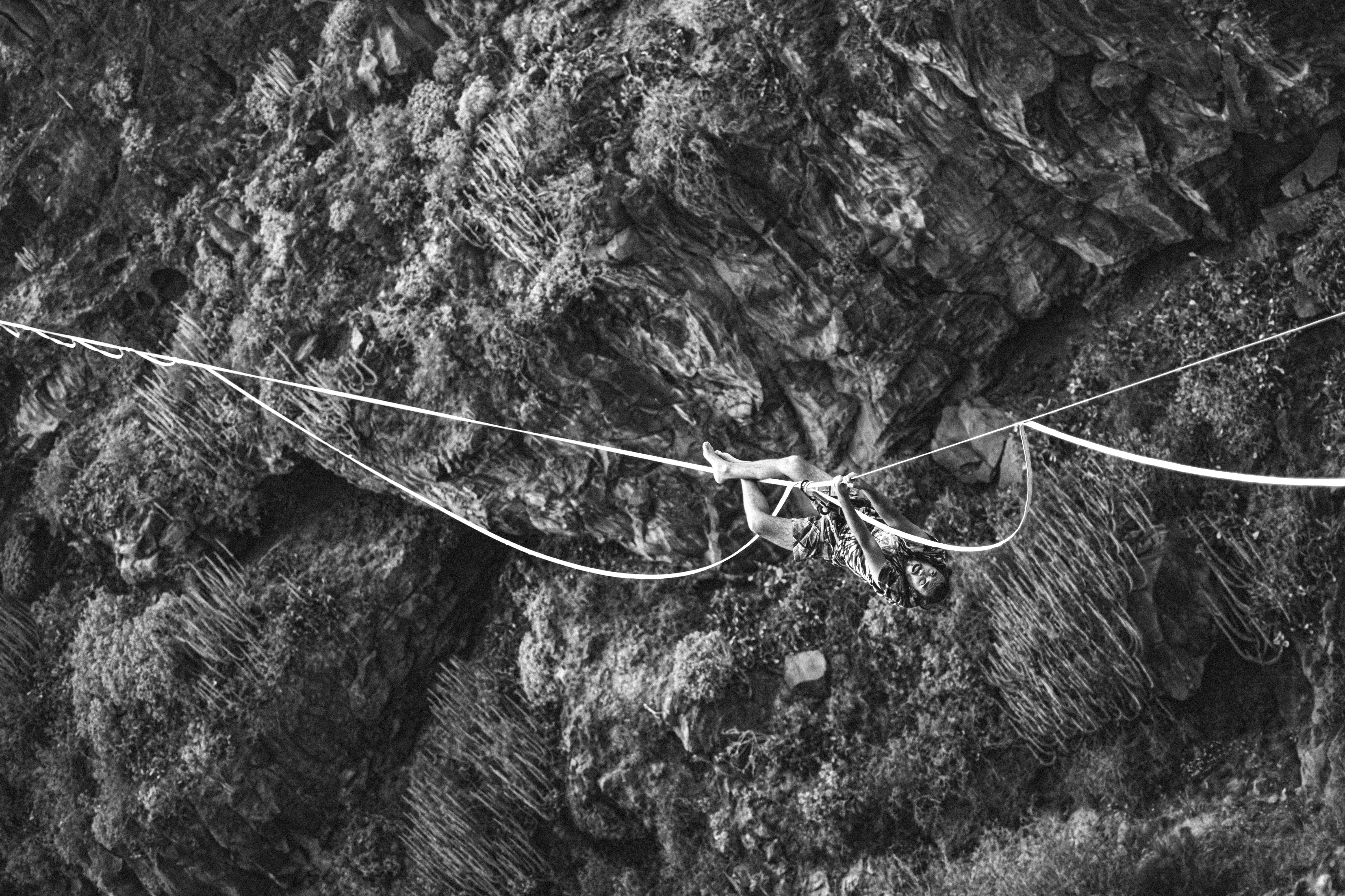 grayscale photo of a hanging bridge