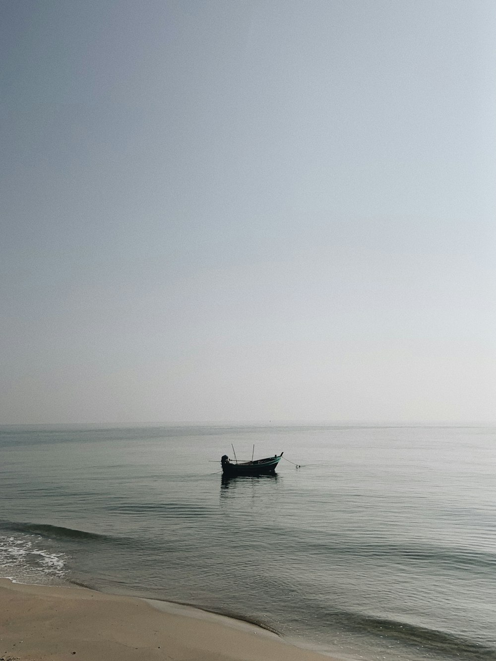 person riding on boat on sea during daytime