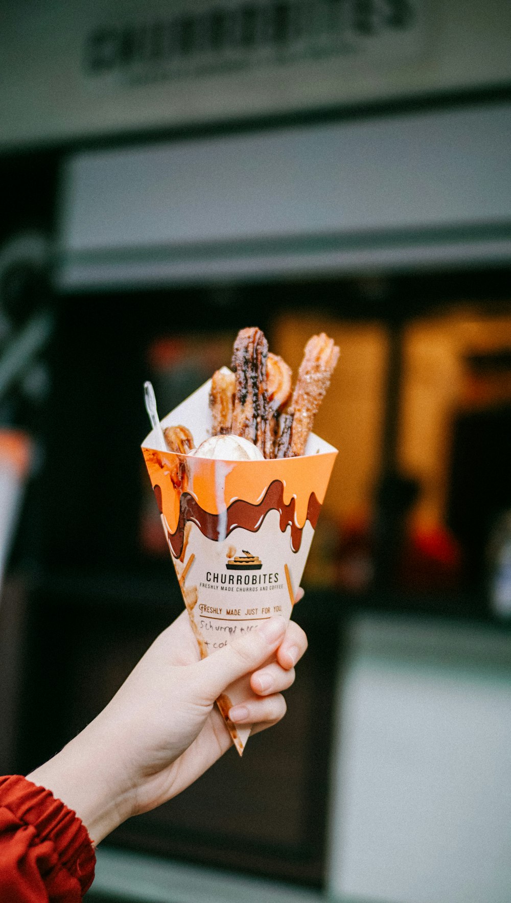 person holding white and brown ice cream cone