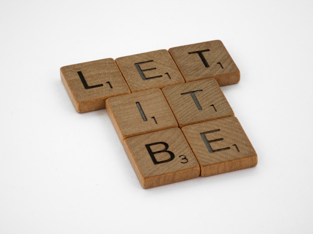 brown wooden puzzle blocks on white surface