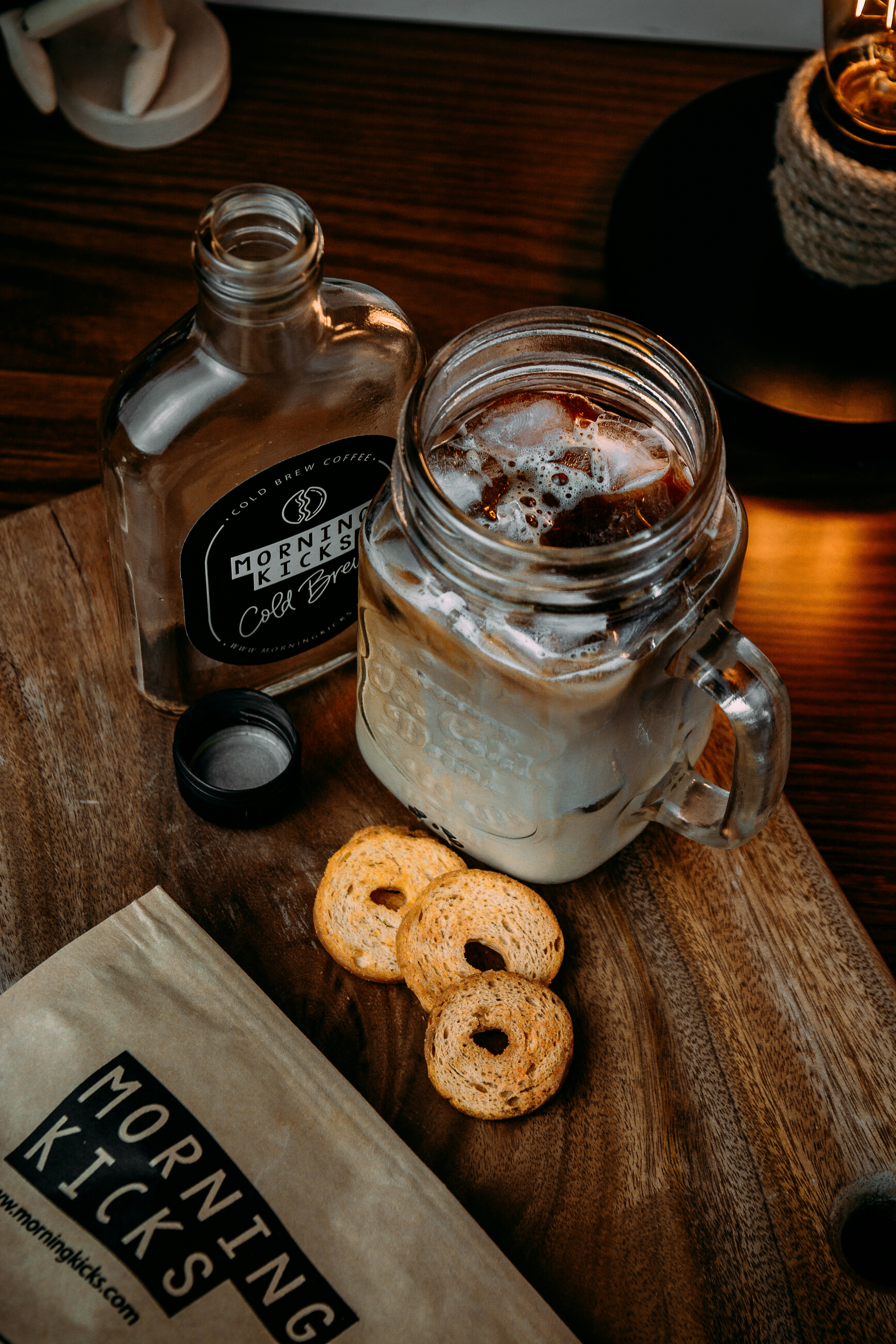 Side-by-side comparison of cold brew in a mason jar and iced coffee in a glass with ice cubes