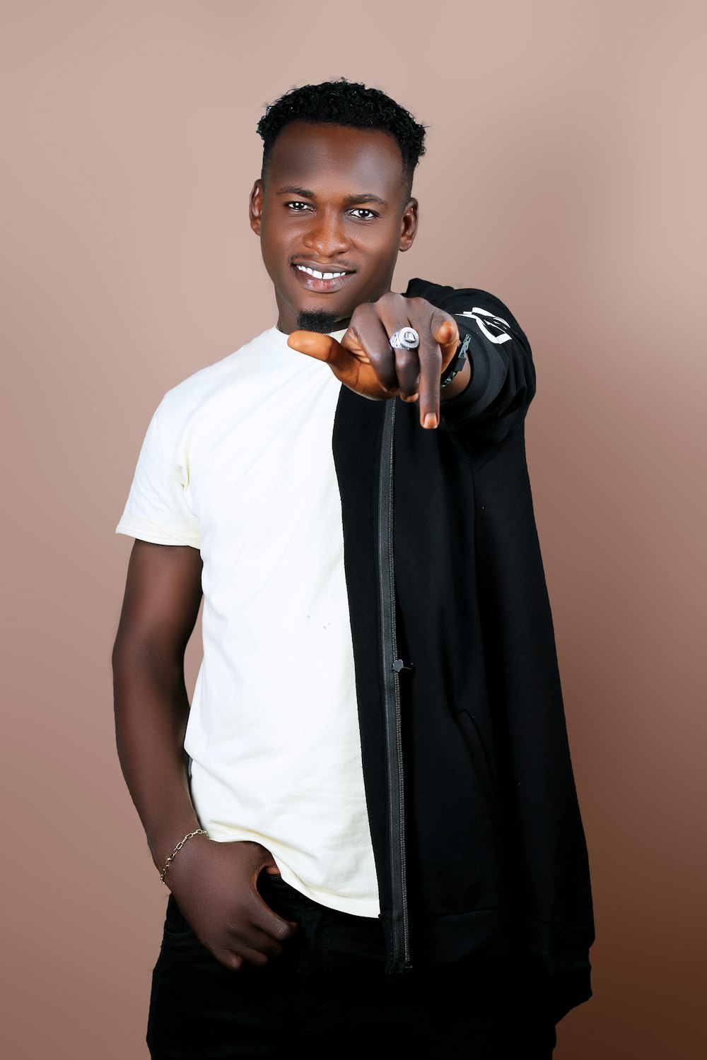 man in white t-shirt holding black textile