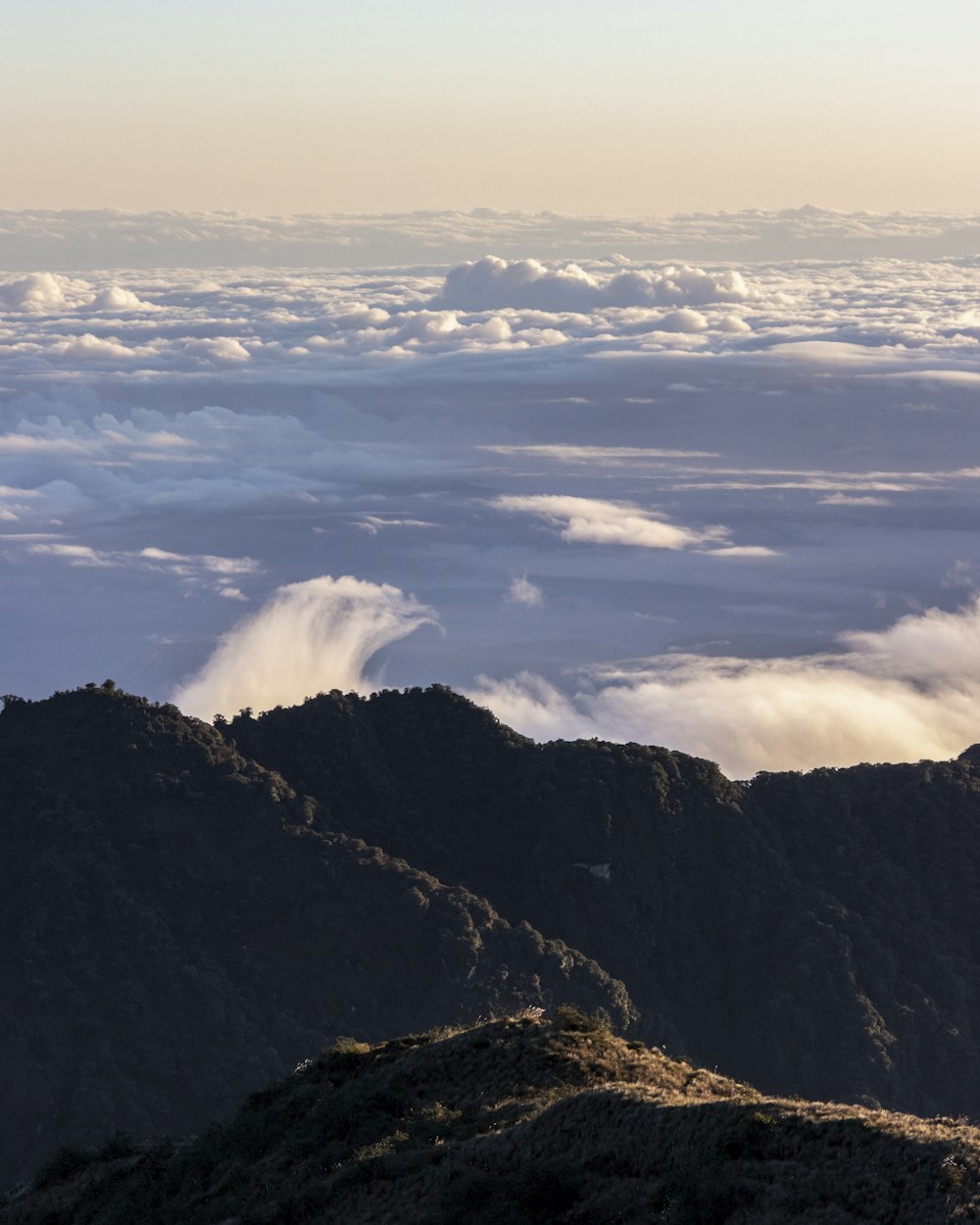 green mountains under white clouds during daytime