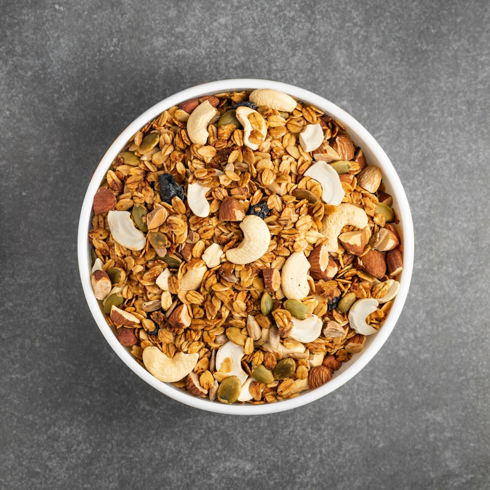 brown peanuts in white ceramic bowl